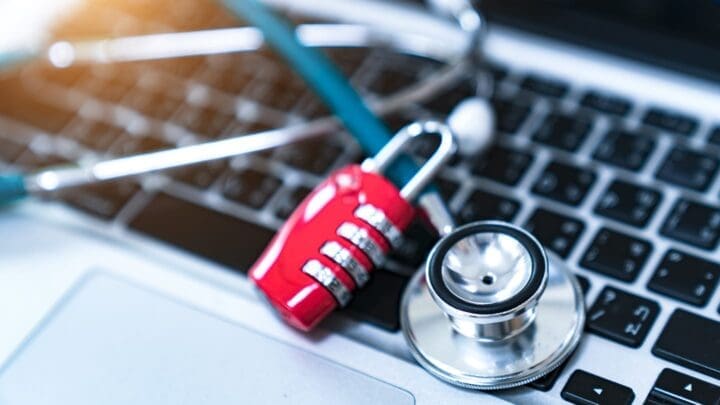 Computer or data analysis - Stethoscope over a laptop computer keyboard toned in blue